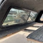 Truck bed cover with tinted window for RAM 1500 in ceramic gray.