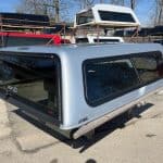 Silver truck cap with tinted windows for F150 9-14 models.