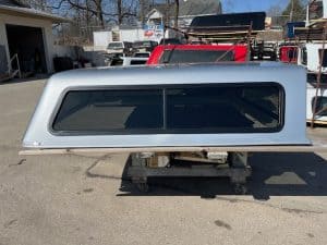 Silver truck cap with tinted window for Ford F150 9-14 model.