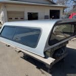 Silver truck cap with tinted windows for F150 9-14 models.