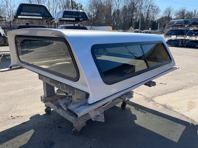 Silver truck cap with tinted windows for F150 9-14 model.