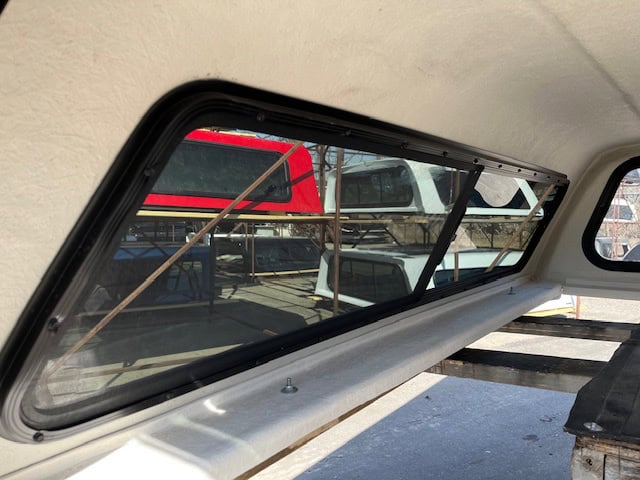 F150 truck window with clear view of the outside and truck bed.
