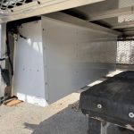 Durable white truck bed storage box for RAM 1500 67" with secure mounting.