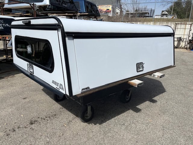 White truck camper shell for Ford SD 81" with black trim and window.
