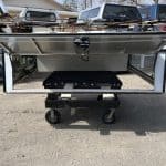White utility bed for Ford SD with open side panels and storage compartments.