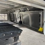 Secure truck bed storage with hydraulic lift for easy access.