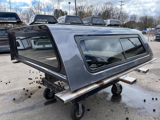 Gray truck cap for Ford F150 79" with tinted windows and aerodynamic design.