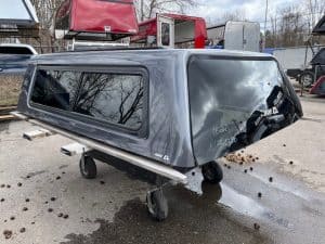 Gray truck cap for Ford F150 with tinted windows and aerodynamic design.