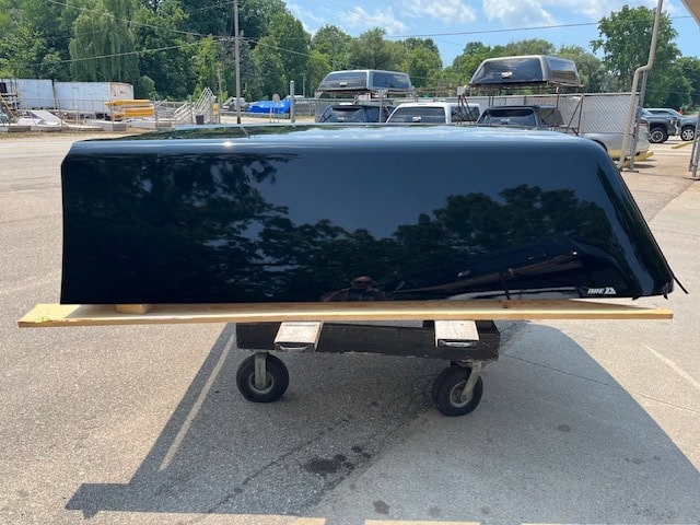 Black tonneau cover for Chevy HD 82" in color 41 black on a cart.