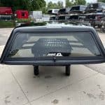 Black Chevy HD 98" truck cap with window and mounting hardware.