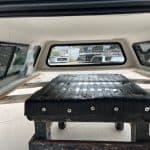 Black truck bed cover for Chevy HD 98" with wooden support structure.