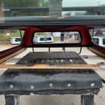 Matte black truck cap installed on a Toyota Tacoma with cargo space.