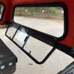 Black truck cap window with sliding panels for Tacoma truck bed.