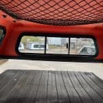 Interior view of a matte black truck cap on a Toyota Tacoma.