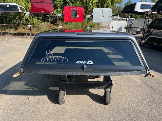 Black truck cap with tinted window and rear window wiper.