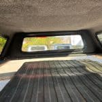 Interior view of a truck cap with a rear window and cargo area.