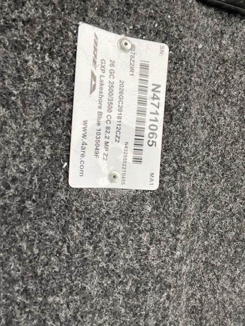 GMC vehicle identification tag with serial and model details.