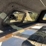 Lakeshore Blue GMC HD truck bed with interior view and window.