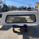 Oxford White truck cap for Ford SD 81.9" with rear window and side panels.