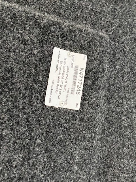 Chevy truck part label on textured surface in Summit White color.