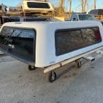 Chevy truck camper shell in Summit White for Silverado pickup.