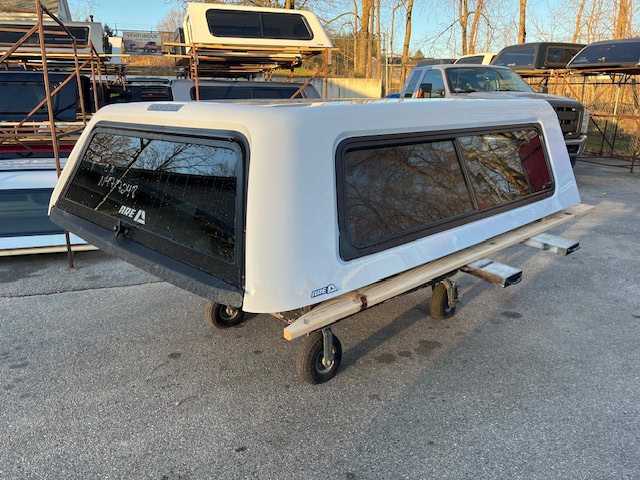 Chevy truck camper shell in Summit White for Silverado pickup.