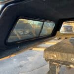 Black truck bed cap with side windows for Chevy 82" models.