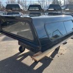 Black truck cap for Chevy HD 82.2" with tinted windows and durable construction.