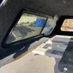 Black truck bed cover with side window for Chevy HD 82.2" model.