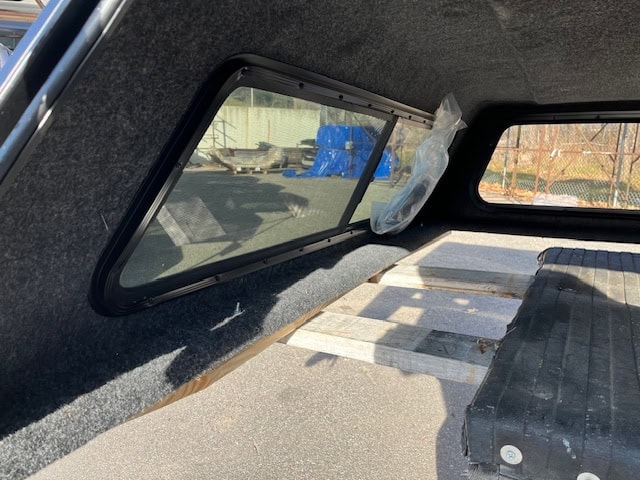 Black truck bed cover with side window for Chevy HD 82.2" model.