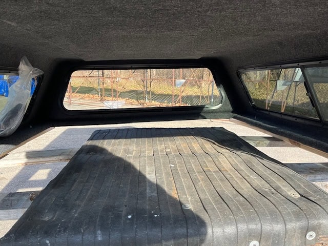 Truck bed cover with black rubber mat for Chevy HD 82.2" model.