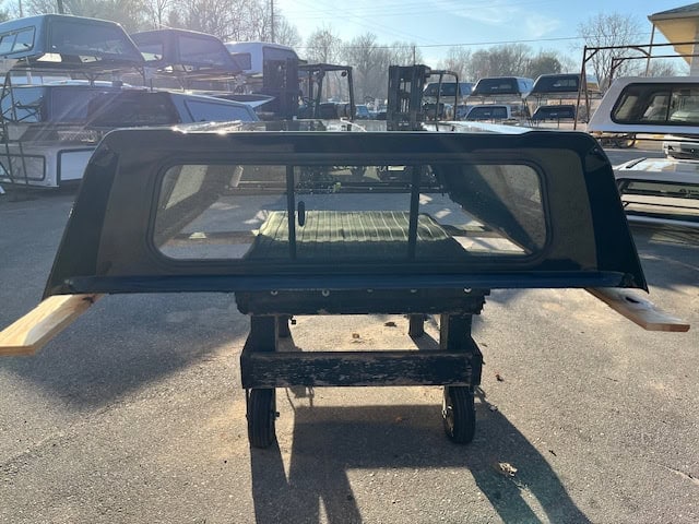 GMC 1500 truck bed with canopy and side rails for pickup truck.
