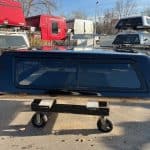 Black truck cap with tinted window for GMC 1500 79" bed.