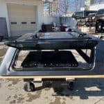 F150 truck cap in gray with tinted windows and roof rack.