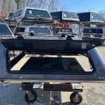 Gray truck cap for F150 with tinted window and aerodynamic design.