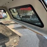 Interior view of Ford SD truck with custom window and bed.