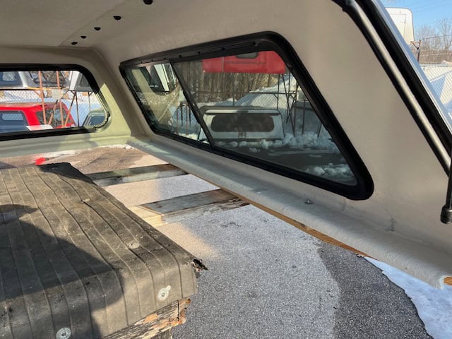Interior view of Ford SD truck with custom window and bed.