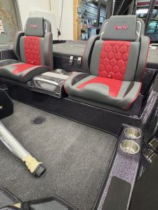 Custom boat seats with red and gray upholstery for comfort and style.