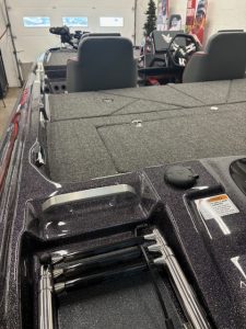 Fishing boat with trolling motor and seating for outdoor recreation.