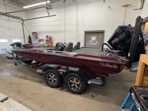 Bass boat with outboard motor on display at Camp & Cruise.