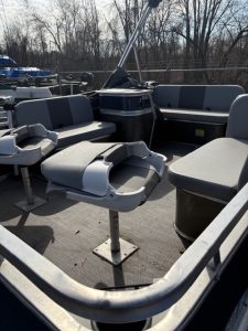 Pontoon boat with comfortable seating and steering console.