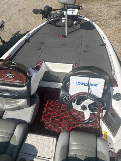 Fishing boat interior with seating, steering wheel, and fishing gear at Camp and Cruise.