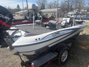 Fishing boat at Camp and Cruise, outdoor display with boat trailer.