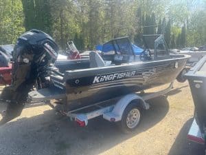 Black KingFisher boat with Mercury outboard motor on trailer at Camp & Cruise.