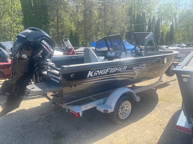 Black KingFisher boat with Mercury outboard motor on trailer at Camp & Cruise.