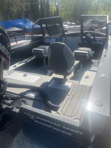 Fishing boat with multiple seats and steering console at Camp & Cruise.
