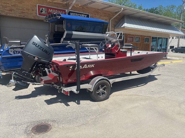 Fishing boat with Suzuki outboard motor at Camp & Cruise, perfect for water adventures.