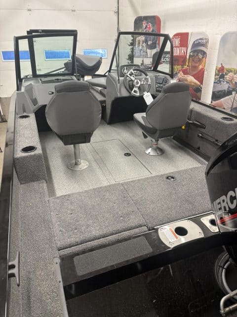 Boat cockpit with steering wheel and dashboard at Camp and Cruise.