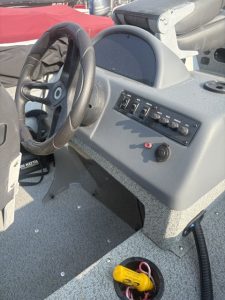 Boat dashboard with steering wheel and controls for Lund 1600 SC Mercury.