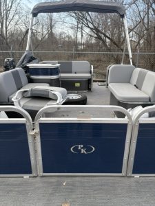 Paddle King LoPro Cruiser pontoon boat with seating and canopy in outdoor setting.